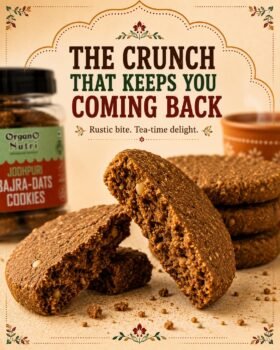 Close up of rustic brown cookies stacked and broken apart with a jar labeled Bajra Dats Cookies in the background and the banner text The Crunch That Keeps You Coming Back above